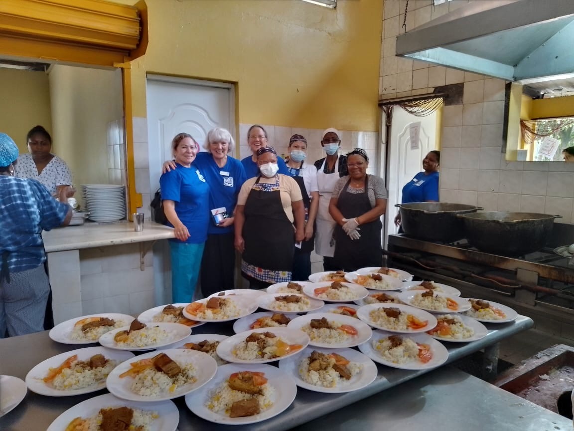 Volunteers with plated meals ready to serve
